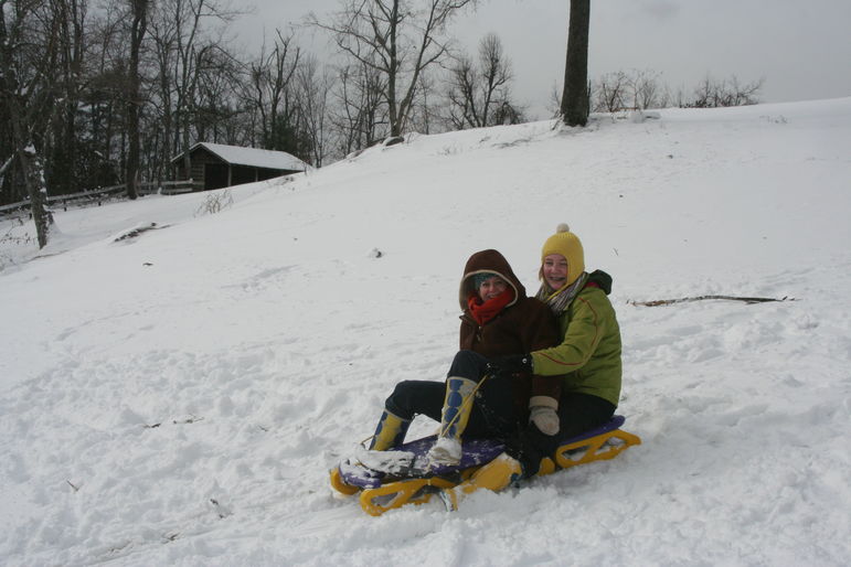 Marisa and Annie sledding at Falling Creek Camp