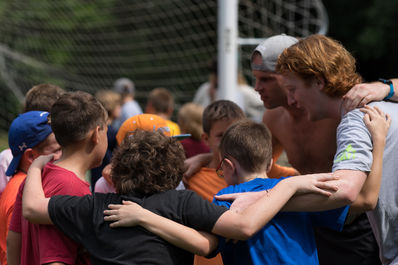 Group huddle at camp before a game.