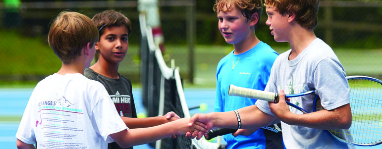 Moral Compass - Campers shaking hands after a tennis match at camp. Good sportsmanship!