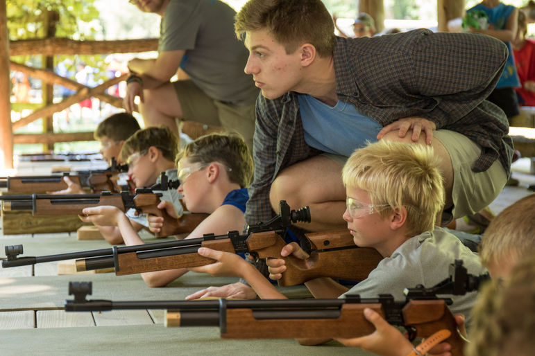 Our riflery staff instruct campers on how to shoot air rifles.