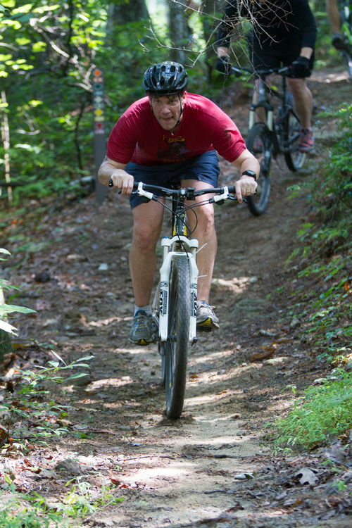 Staff member mountain biking on our extensive trail system at camp.