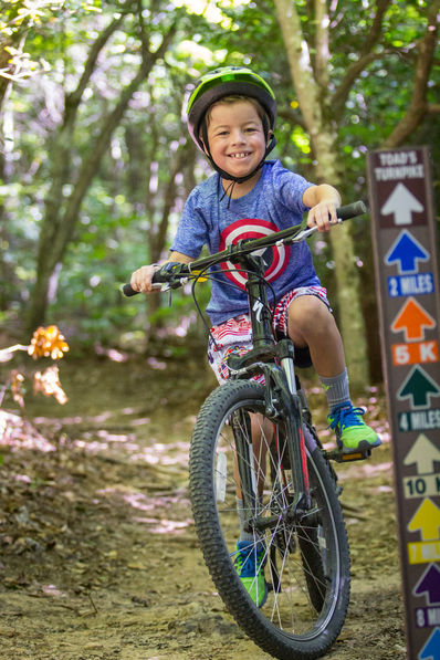 Camper riding mountain biking trails at Falling Creek Camp.