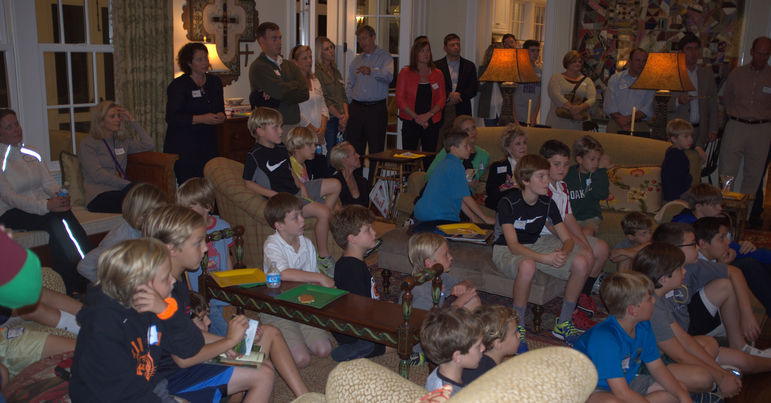 Families, campers, staff, and alumni watching the camp movie in Nashville at the McKee's home in October, 2013