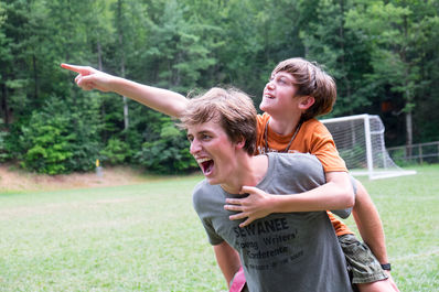 Camper and counselor goofing off at camp.